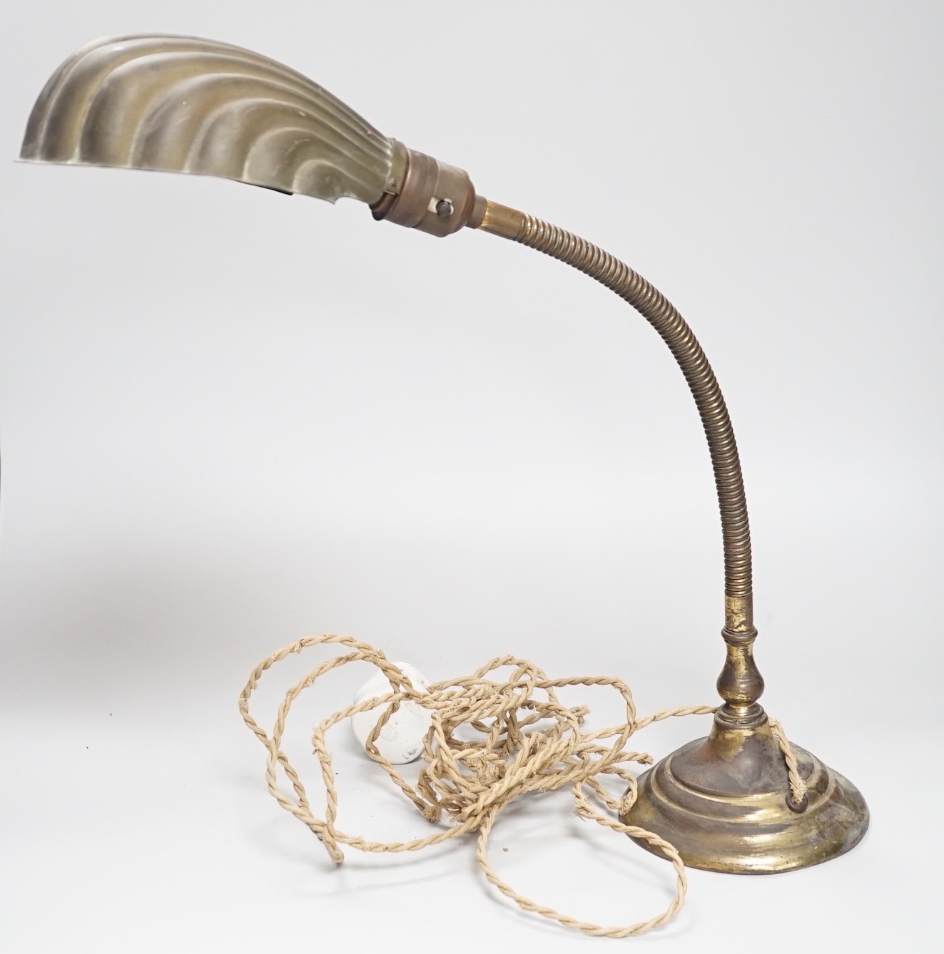 An Edwardian brass adjustable ‘shell’ desk lamp